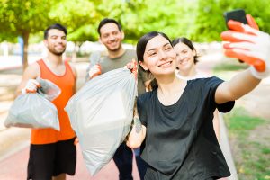 Persone che fanno plogging in un parco per raccogliere rifiuti